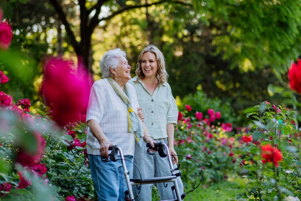 a senior in squamish walking outside in a flower garden