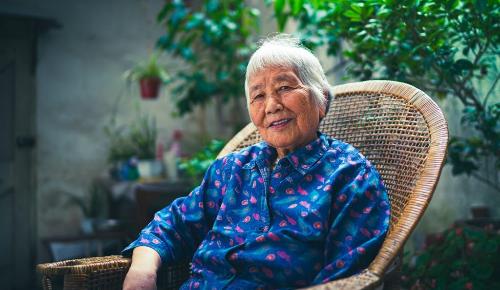 senior smiling in chair